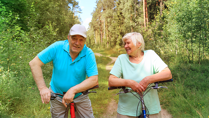 Older couple on bikes.